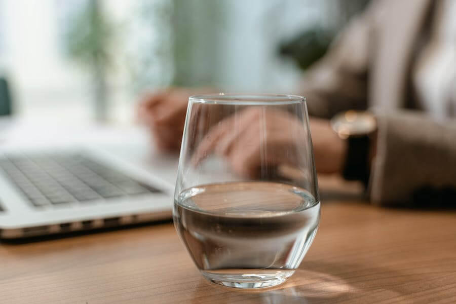 辦公桌中間放著裝有半杯水的玻璃杯